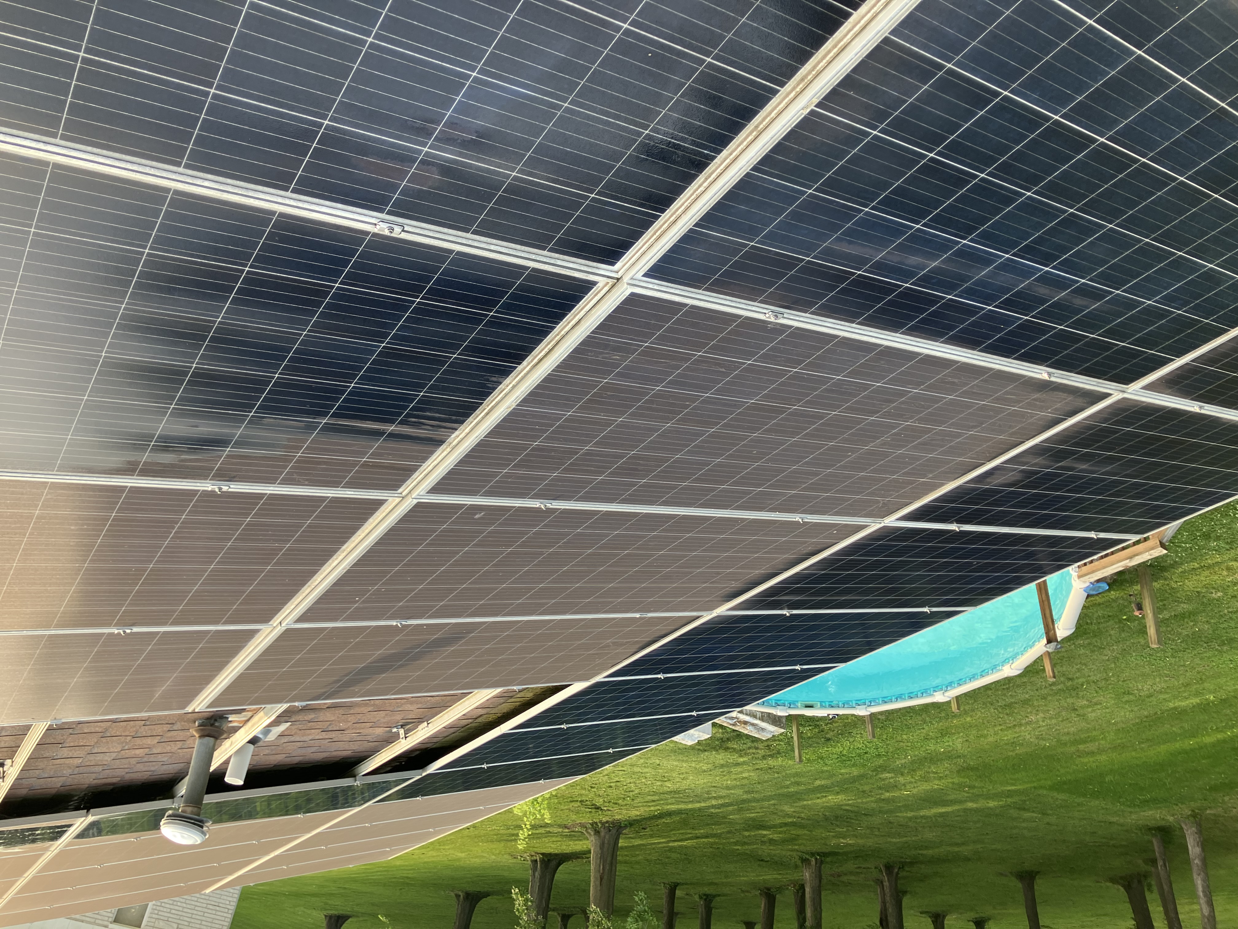 Rooftop solar array after a soft-brush cleaning, viewed from below